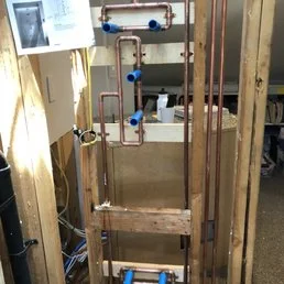 Professional plumber working on residential plumbing system