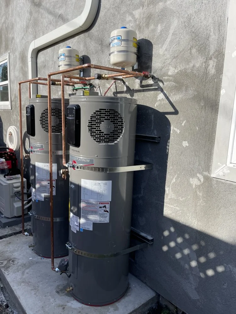 Gas water heater with expansion tank, safety cage, and copper piping installation